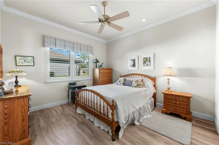 Bedroom featuring light wood-style floors, ornamental molding, ceiling fan, and recessed lighting