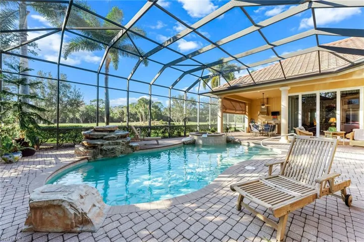 Integrated pool / hot tub featuring a lanai, a sunroom, and a patio area