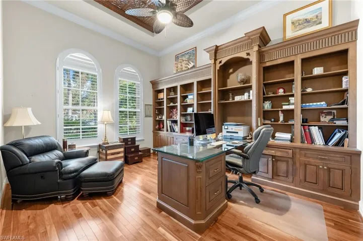 Office featuring a ceiling fan, light wood-style flooring, and crown molding