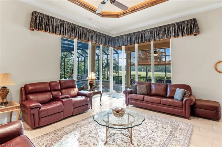 Living area with ceiling fan and crown molding