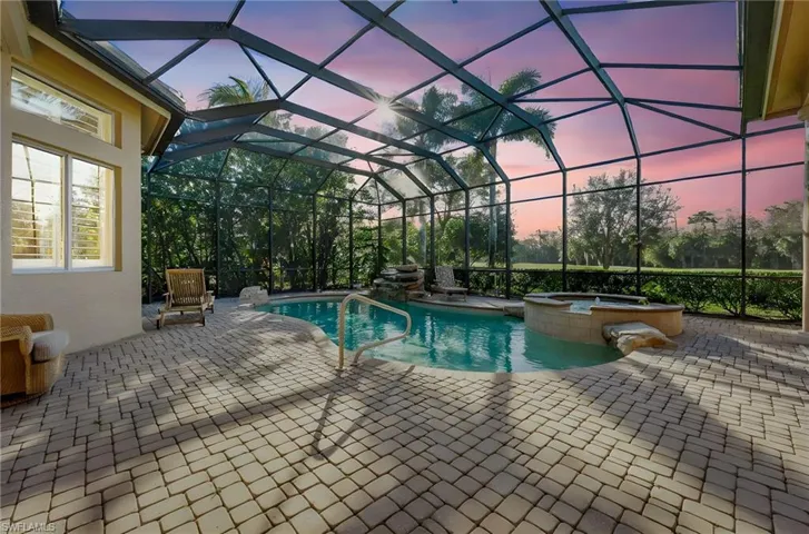 Combined pool / hot tub with a patio, a sunroom, and a lanai