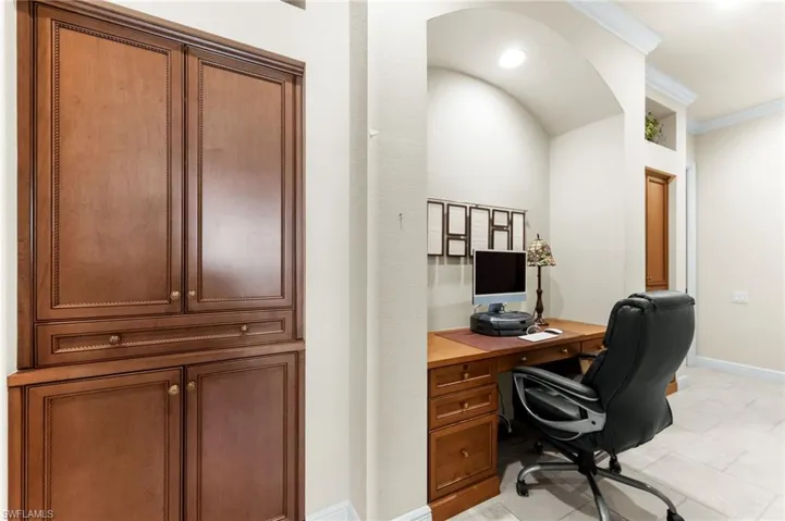 Office featuring crown molding and light tile patterned floors