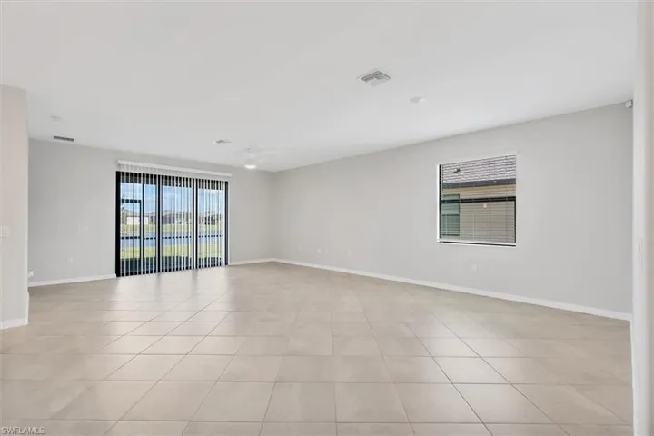 Spare room with baseboards and light tile patterned floors