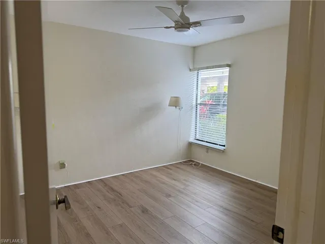 Unfurnished room with wood finished floors and ceiling fan