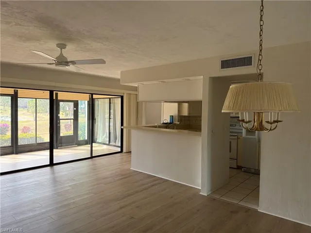 Living area featuring a ceiling fan and light wood finished floors