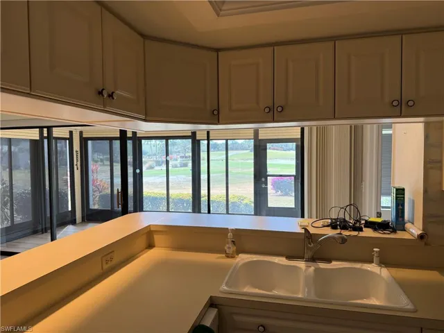 Kitchen featuring a sink and light countertops