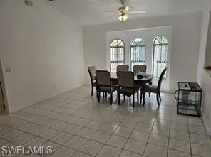 Dining area with ceiling fan and light tile patterned flooring