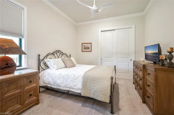 Bedroom with carpet, a closet, and ceiling fan