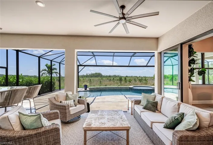Sunroom with plenty of natural light and ceiling fan
