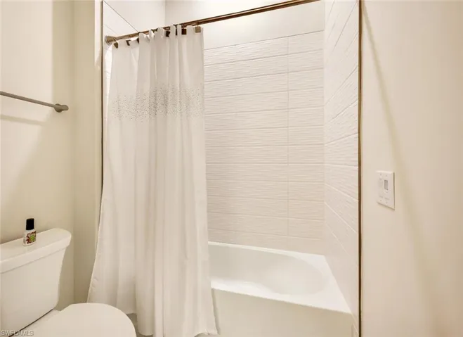 Bathroom with shower / bath combo and toilet