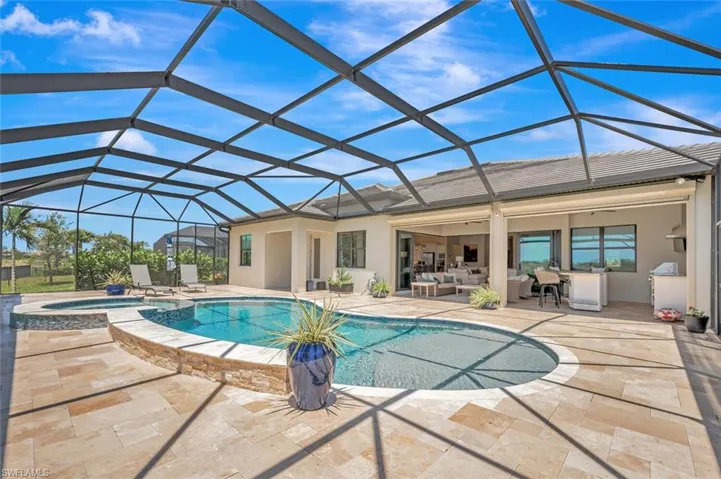 View of pool featuring a lanai, an in ground hot tub, and a patio