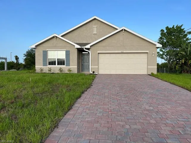 New construction home featuring a stucco exterior and an integrated two-car garage