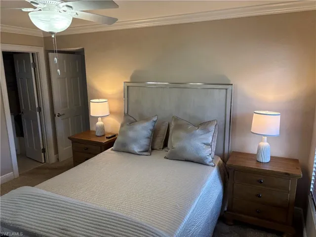 Bedroom with crown molding, carpet flooring, baseboards, and a ceiling fan