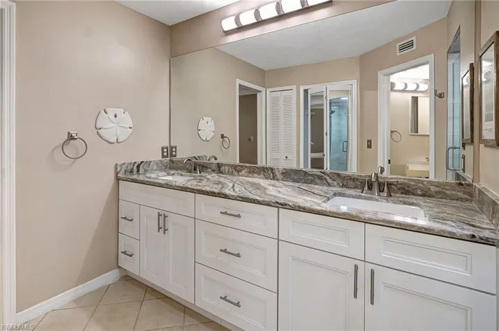 Bathroom with tile patterned floors, vanity, and toilet