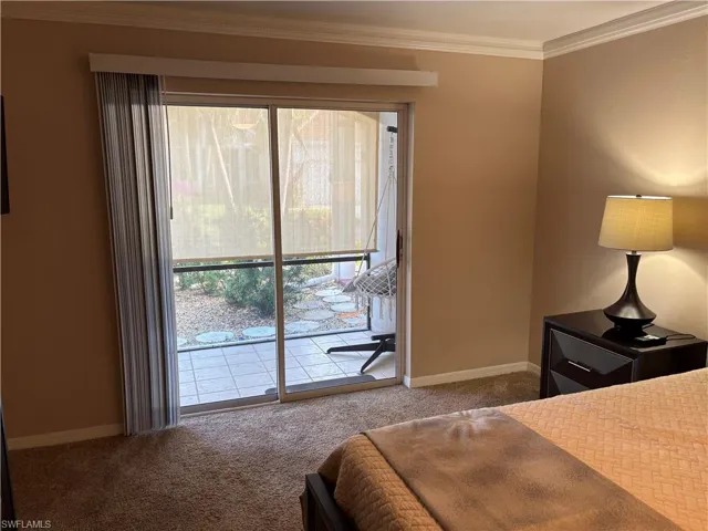 Bedroom featuring carpet, access to exterior, baseboards, and ornamental molding