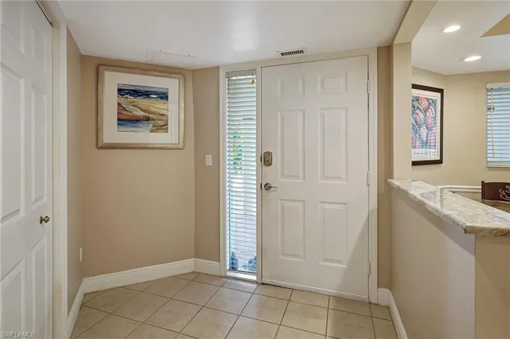 Entrance foyer featuring light tile patterned flooring
