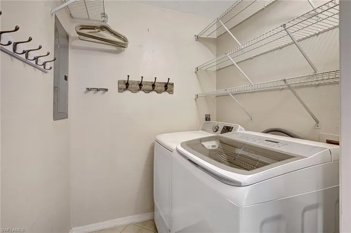 Laundry room featuring tile patterned flooring and washer and dryer