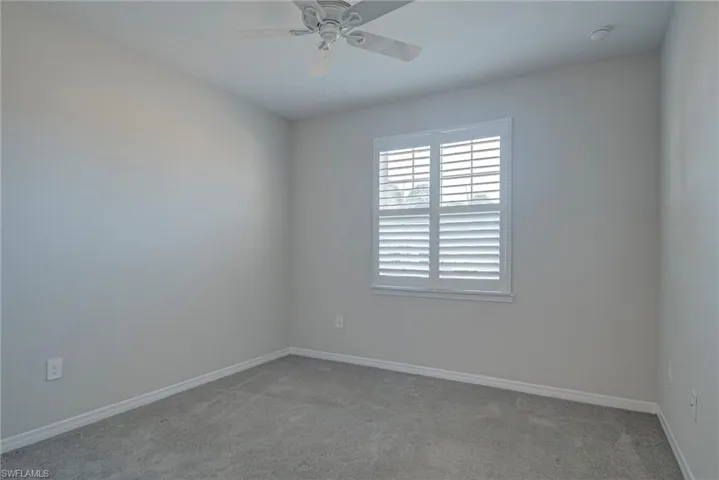Third bedroom featuring baseboards and a ceiling fan