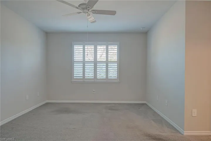 Primary bedroom featuring carpet flooring and a ceiling fan