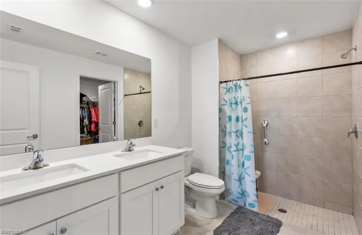 Dual-sink vanity with white cabinetry and chrome fixtures
