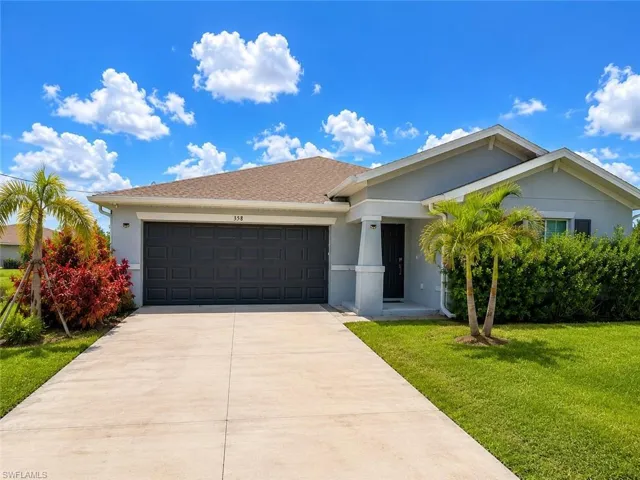 Contemporary single-story residence with a two-car garage, concrete driveway, and covered entry