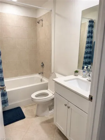 White vanity with shaker-style cabinetry, a built-in rectangular sink, and chrome-finish hardware