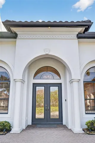 View of exterior entry with french doors and stucco siding