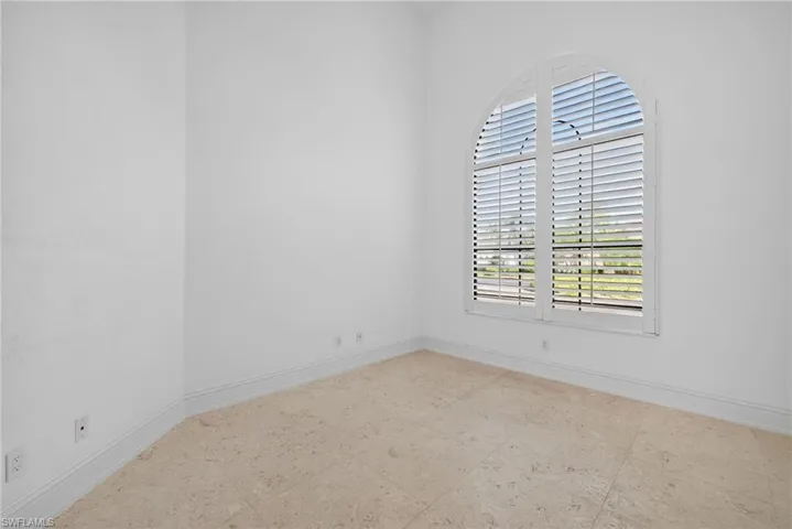 Unfurnished room featuring baseboards