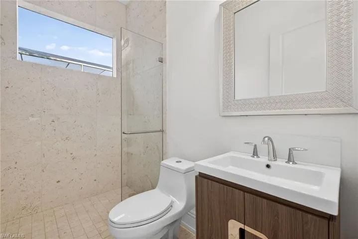 Full bathroom featuring vanity and a tile shower