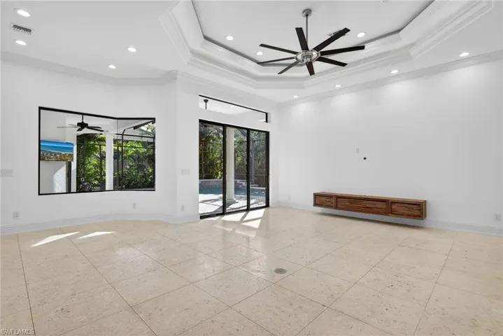 Unfurnished room with ceiling fan, a tray ceiling, ornamental molding, and recessed lighting