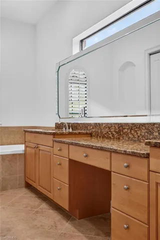 Bathroom with vanity and a bath