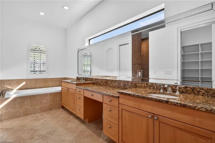 Full bath with double vanity and a bath