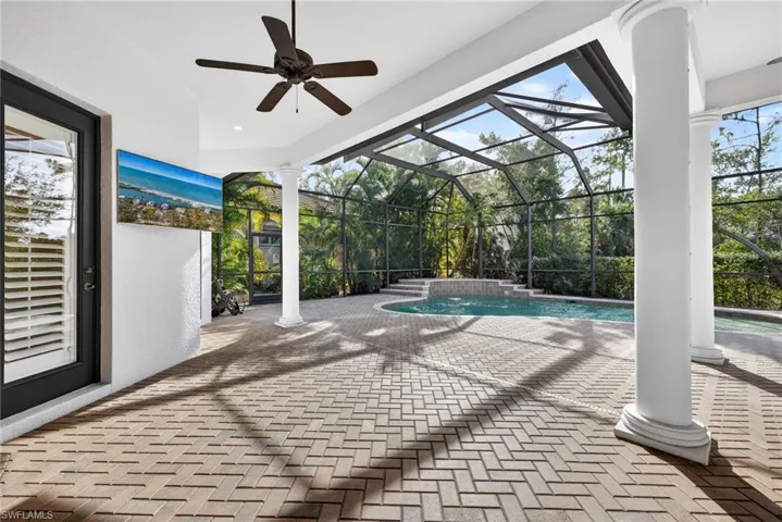 Swimming pool with a patio area, a lanai, a sunroom, and a jacuzzi