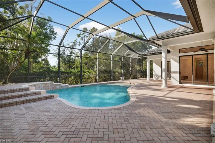 Swimming pool featuring a patio area, a lanai, and a sunroom