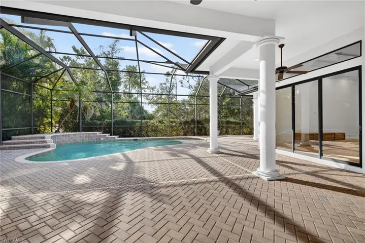 Outdoor pool with a patio area, a lanai, and a sunroom