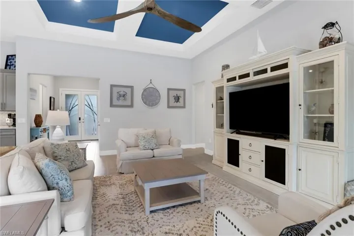 Living room with light hardwood / wood-style flooring and ceiling fan