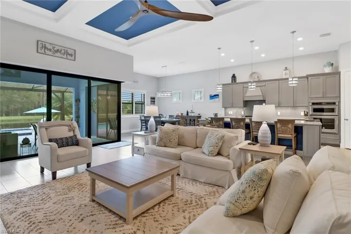 Living room featuring ceiling fan and light tile patterned floors