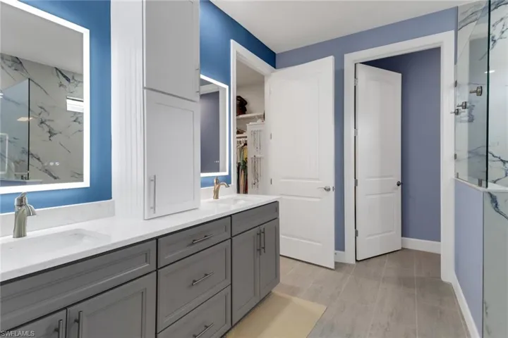 Bathroom featuring vanity and an enclosed shower