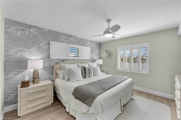 Bedroom with light hardwood / wood-style floors and ceiling fan