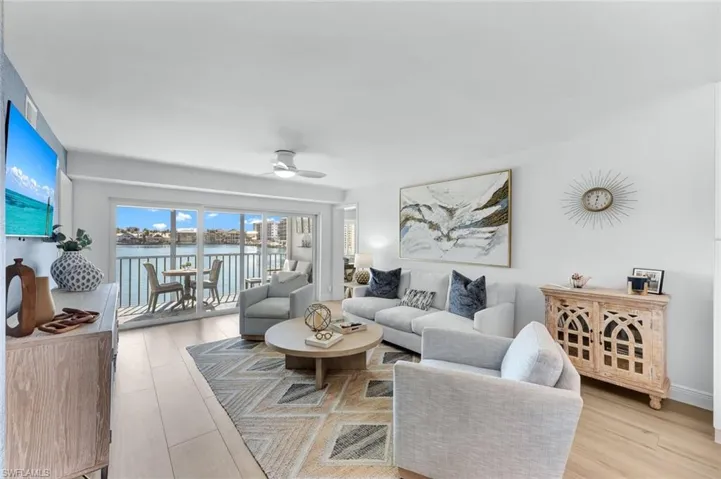 Living room featuring ceiling fan and light hardwood / wood-style floors