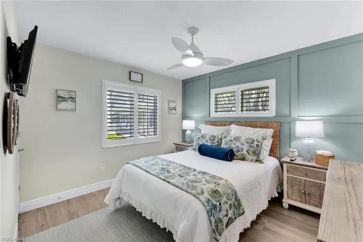 Bedroom with ceiling fan and light hardwood / wood-style floors
