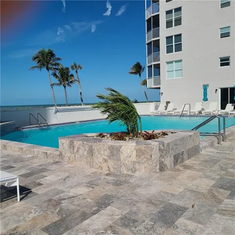 Community pool with a patio