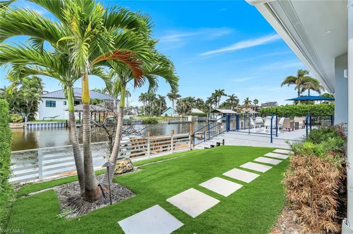 View of yard featuring a water view, a patio, and a boat dock