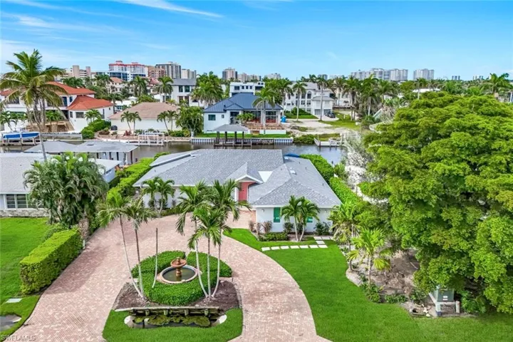 Aerial perspective of suburban area featuring a large body of water