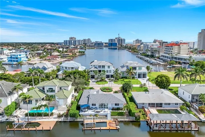 View of urban area with a large body of water, nearby suburban area, and a marina