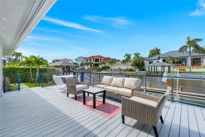 Wooden deck featuring outdoor lounge area, a gazebo, and a residential view