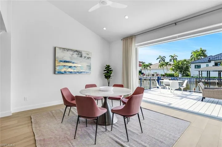Dining room with vaulted ceiling, recessed lighting, light wood-type flooring, and ceiling fan