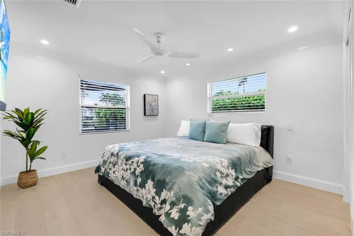 Bedroom with ornamental molding, recessed lighting, a ceiling fan, and light wood-style floors