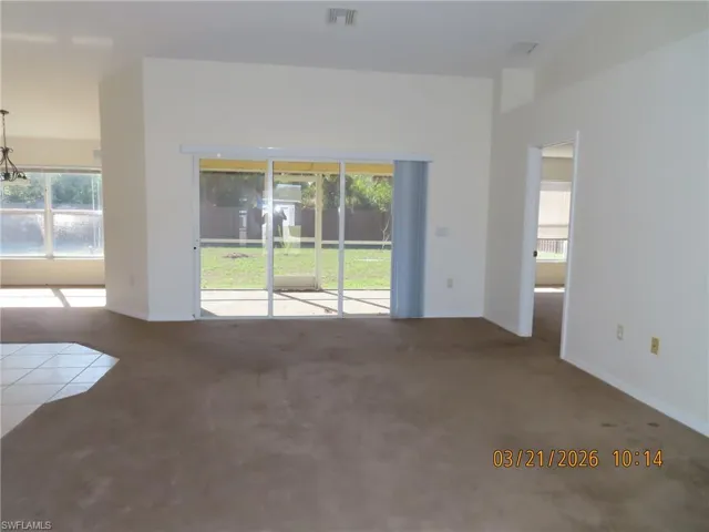 Unfurnished room featuring carpet and healthy amount of natural light