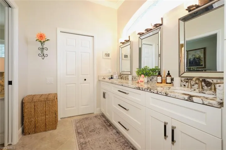 Bathroom with tile patterned floors, vanity, and ornamental molding